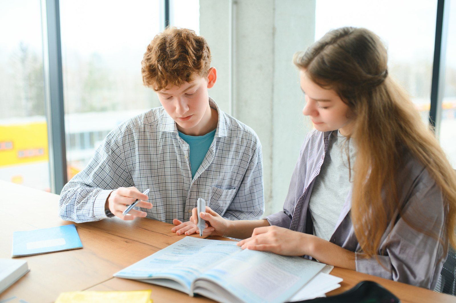 Teenage students working together at a table