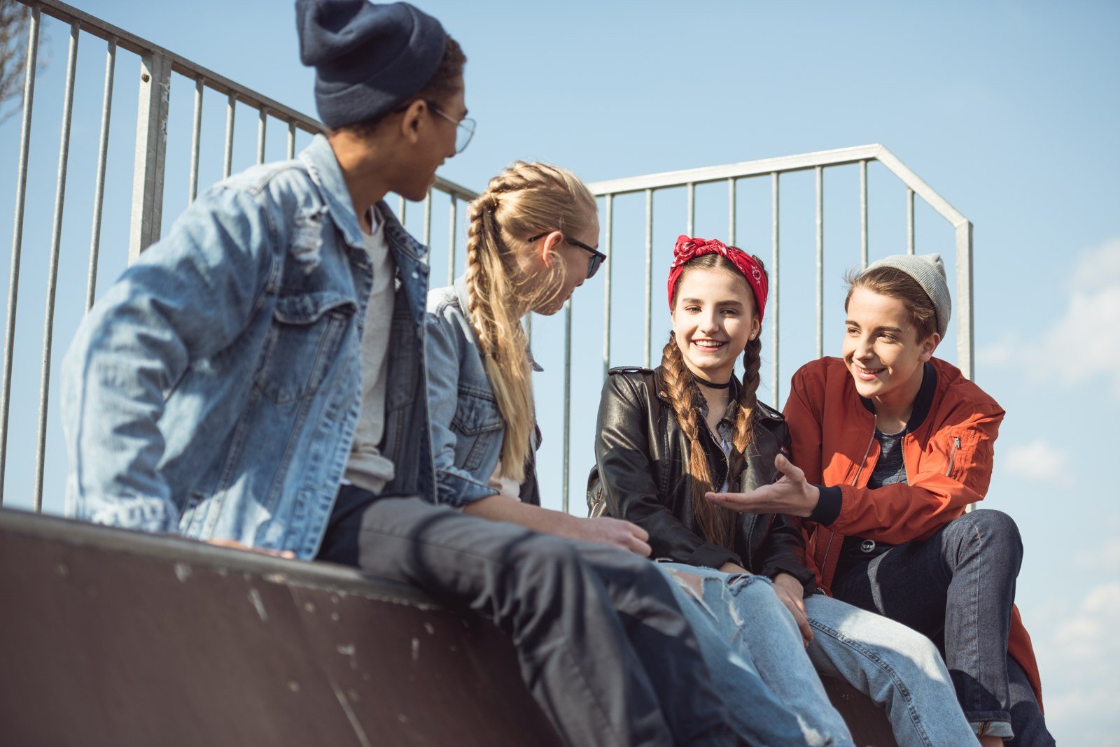 Teenage friends talking at a skate park