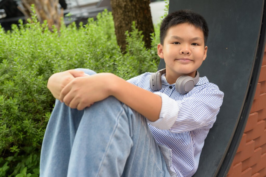 Teen with headphones outdoors for Toronto ADHD assessment and support article
