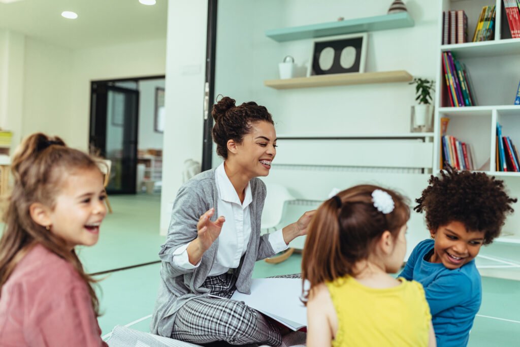 Teacher leading a small group of children in a classroom activity.