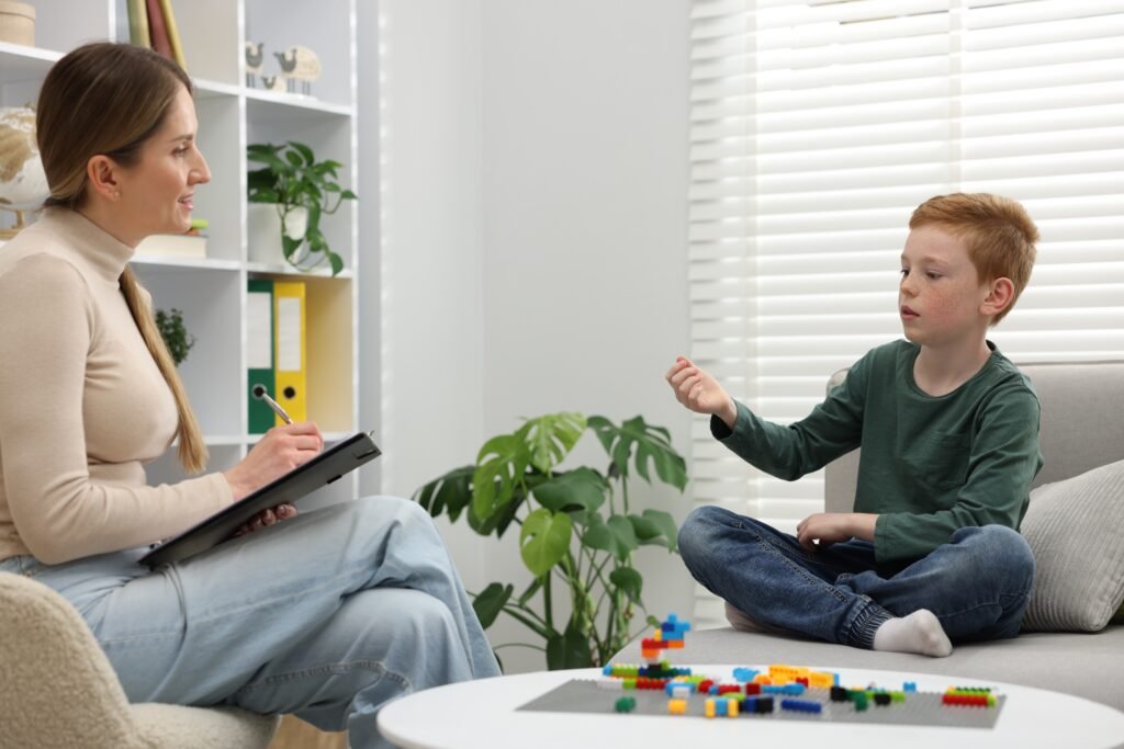 Boy talking with a woman who is taking notes.